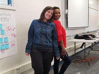 two teachers standing side by side 